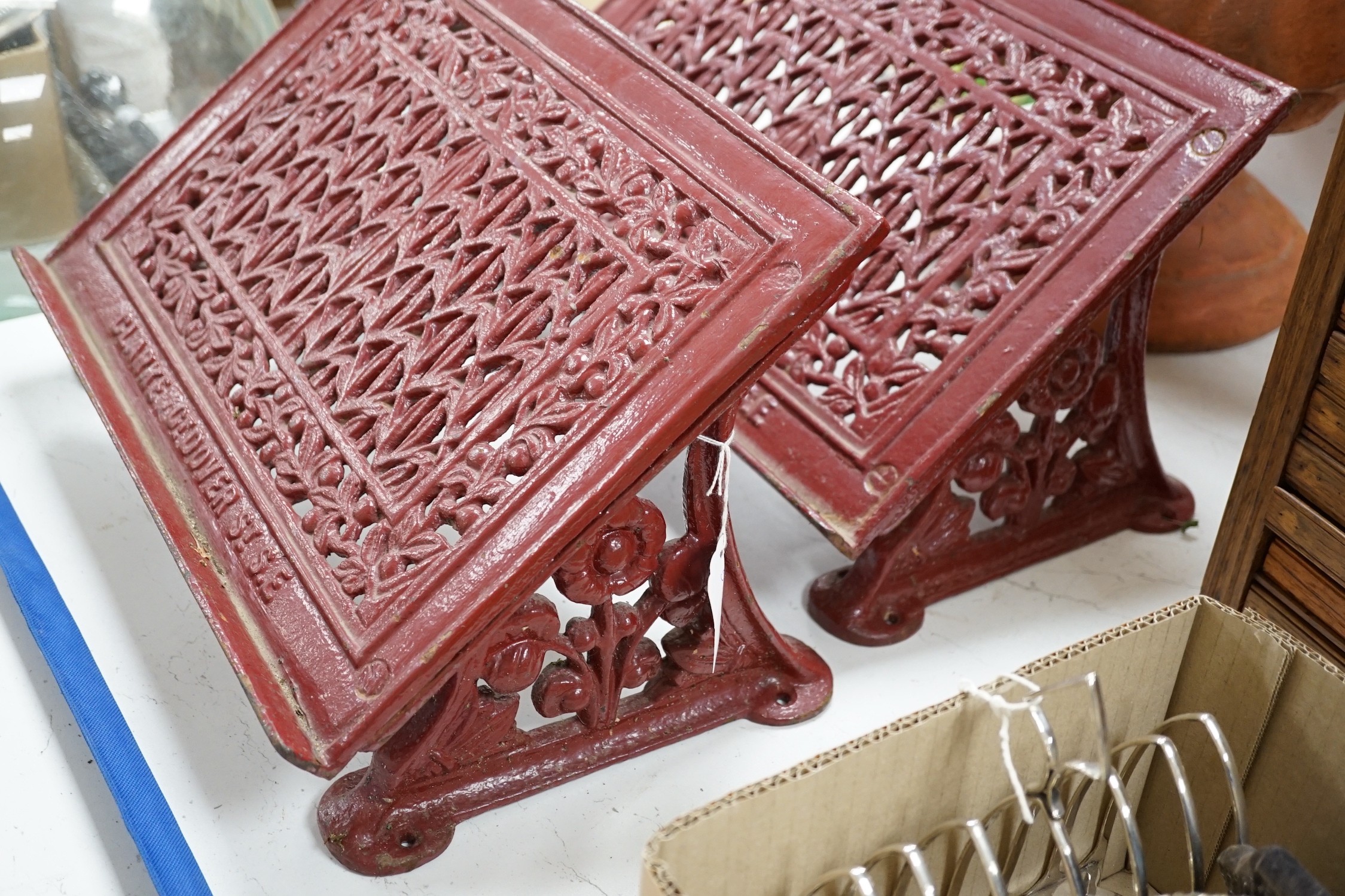 A pair of painted cast iron lecterns marked ‘CLARKE CT DOVER ST S.E’ 42cm wide